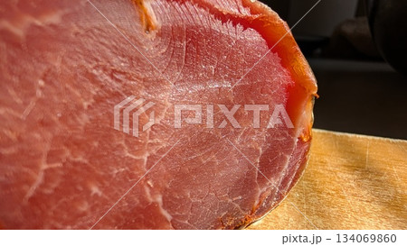 A CloseUp View of Deliciously Sliced Meat Arranged Beautifully on a Rustic Wooden Board A CloseUp View of Deliciously Sliced Meat Arranged Beautifully on a Rustic Wooden Board 134069860