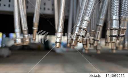 A Detailed CloseUp of Silver Metal Hoses Complete with Their Connectors and Fittings A Detailed CloseUp of Silver Metal Hoses Complete with Their Connectors and Fittings 134069953