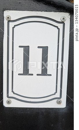 The number 11 is prominently featured on a stark black background, creating a striking visual The number 11 is prominently featured on a stark black background, creating a striking visual 134070015