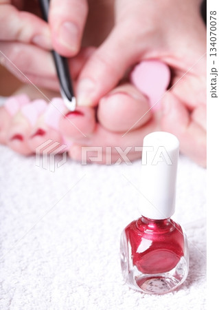 female feet red polished nails 134070078