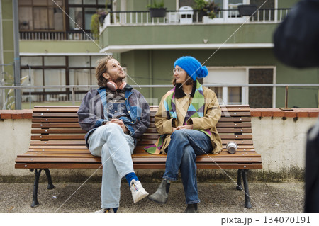 Lively young pair relaxing together amid city rooftop scenery Lively young pair relaxing together amid city rooftop scenery 134070191