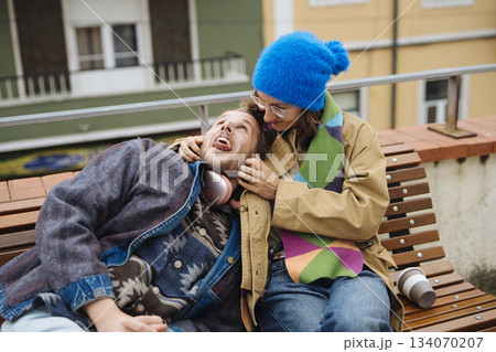 Couple exchanging gentle forehead kiss with urban skyline background 134070207