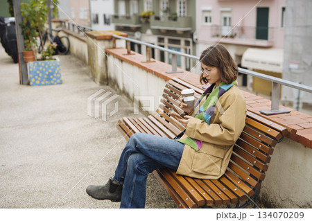 Casual friends share laughs and drinks on urban rooftop during daytime 134070209