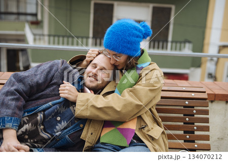 Affectionate pair sharing gentle embrace in urban outdoor setting 134070212