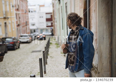 Individual examining street, Man in casual attire on city street 134070239