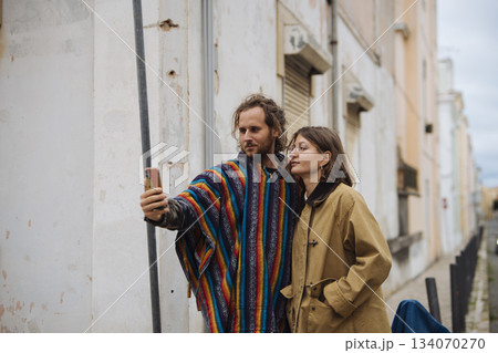 Two individuals seeking directions through colorful urban alleyways Two individuals seeking directions through colorful urban alleyways 134070270