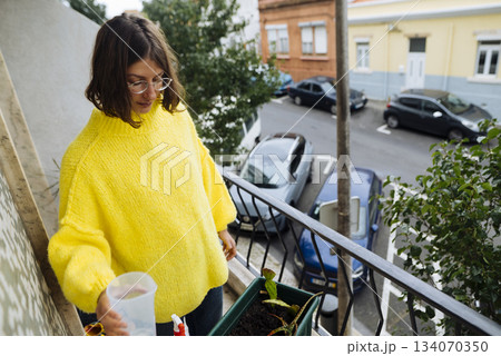 caucasian woman plant blogger creating balcony content caucasian woman plant blogger creating balcony content 134070350