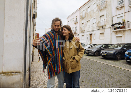 Loving partners enjoying serene walk through historic district hand in hand 134070353