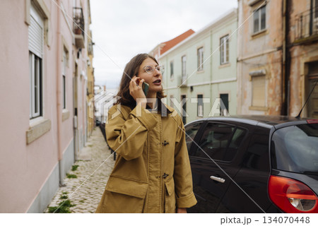Serene evening portrait of woman engaged with her device Serene evening portrait of woman engaged with her device 134070448