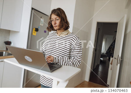 Focused woman analyzing business data on her personal computer 134070463