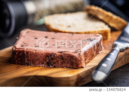 Liver pate with cranberries on wooden cutting board. Liver pate with cranberries on wooden cutting board. 134070824