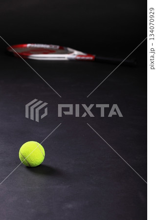 tennis racket and balls on black background 134070929