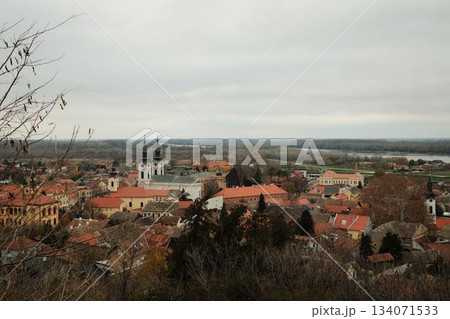 Historic rooftops of Sremski Karlovci with iconic yellow architecture and church towers. The scene conveys heritage, culture, and timeless atmosphere Historic rooftops of Sremski Karlovci with iconic yellow architecture and church towers. The scene conveys heritage, culture, and timeless atmosphere 134071533