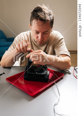 Technician performing computer hardware maintenance, installing cpu cooling system, ensuring optimal performance for modern gaming or workstation setups and repairing. 134072049