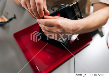 Close-up of technician performing maintenance and installation on sophisticated cooling system for computer cpu, ensuring efficient heat dissipation and enhanced system stability at workshop. 134072058