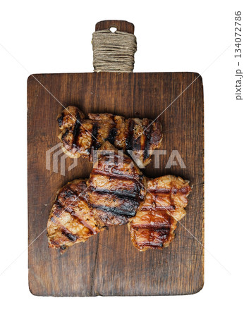 Three grilled steaks on a wooden board, isolated background Three grilled steaks on a wooden board, isolated background 134072786