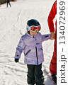 Ski coach giving a lesson to a child 134072969