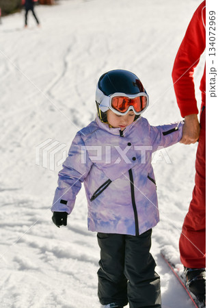 Ski coach giving a lesson to a child Ski coach giving a lesson to a child 134072969