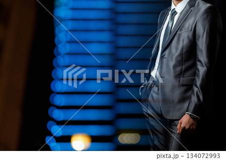 Man poses by blue lights. 134072993