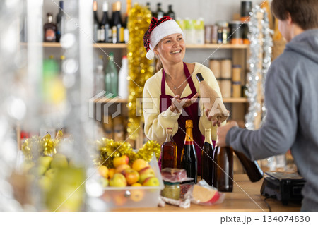 Young woman seller offers wine to buyer 134074830