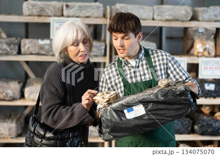 Guy consultant seller, presents mycelium to senior female buyer Guy consultant seller, presents mycelium to senior female buyer 134075070