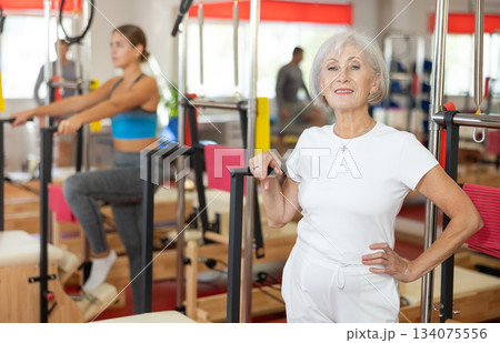 Elderly woman posing in pilates studio 134075556