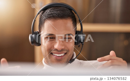 Call center, man and happy with smile on face at desk in office for sales and customer support, Male agent or consultant in telemarketing, support and crm with headphones for help desk communication 134076582