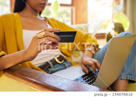 Woman, laptop and credit card with ecommerce, closeup of hands with online shopping and bank app. Female relax at home, fintech and internet banking with payment, retail store website and finance Woman, laptop and credit card with ecommerce, closeup of hands with online shopping and bank app. Female relax at home, fintech and internet banking with payment, retail store website and finance 134076610