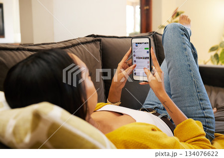 Phone, hands and woman on social media on sofa in home living room, typing or texting. Cellphone, relax and person or female web scrolling, online browsing or networking, reading and messaging alone 134076622