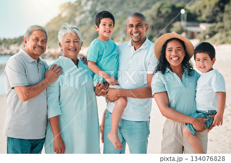 Family, parents and grandparents portrait at beach and children with a smile, happiness and care together. Happy boy kids, men and women on holiday, adventure or vacation outdoor for summer travel 134076828