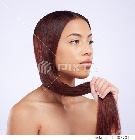 Haircare, beauty and woman holding hair, straight hairstyle and luxury salon shine isolated on white background. Haircut, keratin glow and serious expression of Brazilian model in studio backdrop. 134077010
