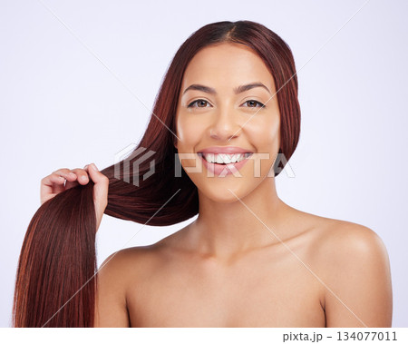 Portrait of happy woman with hair in hands, beauty and care for straight haircut and luxury salon shine on white background. Haircare, glow and happiness, face of Brazilian model on studio backdrop. 134077011