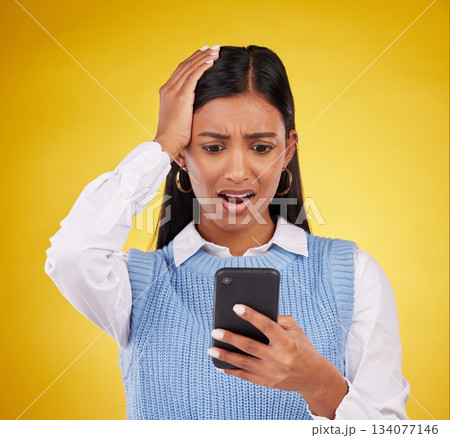 Problem, bad news and a woman with a notification on a phone isolated on a studio background. Sad, glitch and an indian girl reading a message on a mobile app with shock and surprise on a backdrop Problem, bad news and a woman with a notification on a phone isolated on a studio background. Sad, glitch and an indian girl reading a message on a mobile app with shock and surprise on a backdrop 134077146