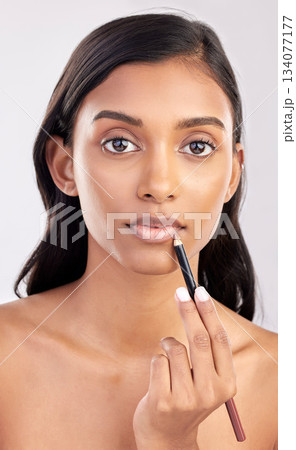 Woman apply lip liner, face and portrait with makeup, beauty and cosmetic product on studio background. Indian female, cosmetics pencil for lips and lipstick with healthy skin and cosmetology Woman apply lip liner, face and portrait with makeup, beauty and cosmetic product on studio background. Indian female, cosmetics pencil for lips and lipstick with healthy skin and cosmetology 134077177