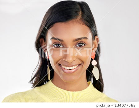 Portrait, fashion and beauty with a woman on a white background in studio wearing earrings or accessories. Face, smile and happy with an attractive young indian female closeup for contemporary style Portrait, fashion and beauty with a woman on a white background in studio wearing earrings or accessories. Face, smile and happy with an attractive young indian female closeup for contemporary style 134077368