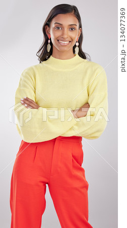Fashion, portrait and woman model in studio with a stylish, trendy and classy elegant outfit. Smile, style and young Indian female posing with crossed arms for confidence isolated by gray background. Fashion, portrait and woman model in studio with a stylish, trendy and classy elegant outfit. Smile, style and young Indian female posing with crossed arms for confidence isolated by gray background. 134077369