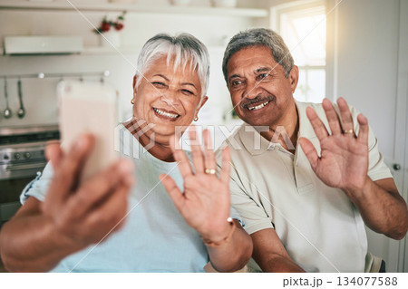 Video call, waving and elderly couple on phone, happy and smile in their home kitchen. Smartphone, love and old people greeting, excited and cheerful for online conversation and enjoying retirement Video call, waving and elderly couple on phone, happy and smile in their home kitchen. Smartphone, love and old people greeting, excited and cheerful for online conversation and enjoying retirement 134077588