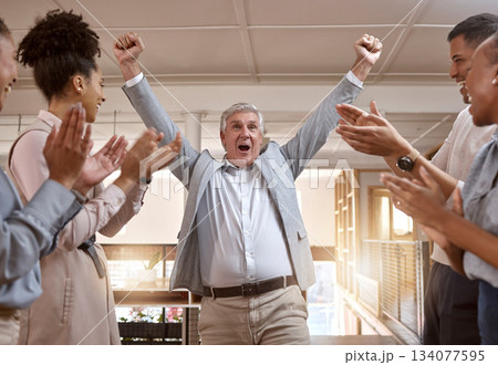 Business people, celebration and winning with applause for promotion, success or teamwork at office. Happy senior businessman in joy for win, victory or achievement with team clapping at workplace 134077595