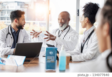 Medical team, meeting and doctor speaker in a hospital conference room for healthcare seminar. Collaboration, teamwork and wellness staff in a conversation for doctors innovation and management 134077640