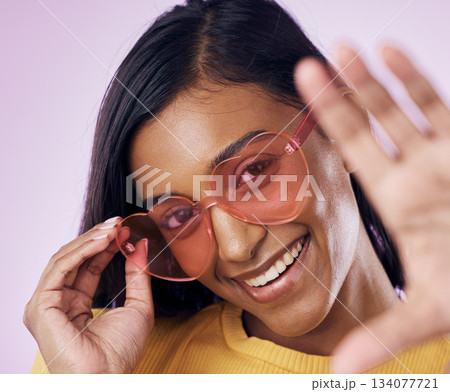 Heart, sunglasses and indian woman selfie in studio happy, cheerful and fun on purple background. Glasses, portrait and female gen z fashion influencer smile for profile picture, photo or blog post Heart, sunglasses and indian woman selfie in studio happy, cheerful and fun on purple background. Glasses, portrait and female gen z fashion influencer smile for profile picture, photo or blog post 134077721