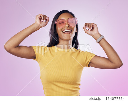 Dance, sunglasses and happy woman excited, cool and confident isolated in a pink studio background with joy. Singing, music and young gen z female dancing celebration of a party energy with glasses Dance, sunglasses and happy woman excited, cool and confident isolated in a pink studio background with joy. Singing, music and young gen z female dancing celebration of a party energy with glasses 134077734