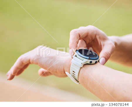 Hands, exercise and smart watch with a sports person outdoor, checking the time during a workout. Arm, fitness and technology with an athlete tracking cardio or endurance performance while training Hands, exercise and smart watch with a sports person outdoor, checking the time during a workout. Arm, fitness and technology with an athlete tracking cardio or endurance performance while training 134078144