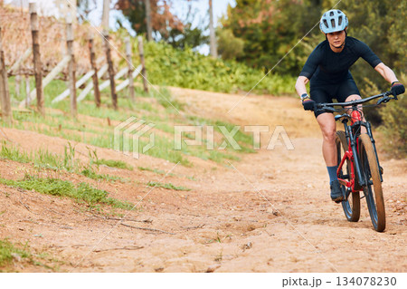 Bicycle, ride outdoor and woman on a bike with cycling for sports race on a road with mockup. Fitness, exercise and fast athlete doing sport training in nature on a park trail for cardio and workout 134078230