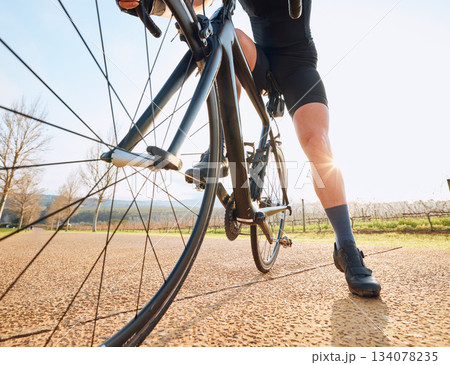 Closeup, bicycle wheel and cycling in nature on countryside street for rest, wellness or fitness. Cyclist woman, bike and sustainable travel in summer for adventure, health and tired on road workout Closeup, bicycle wheel and cycling in nature on countryside street for rest, wellness or fitness. Cyclist woman, bike and sustainable travel in summer for adventure, health and tired on road workout 134078235