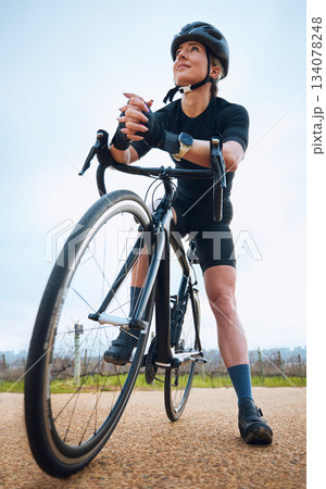 Thinking, cycling and fitness with woman in nature for training, workout or sports cardio. Health, relax and strong with female cyclist riding on bike in outdoor for exercise, endurance and challenge Thinking, cycling and fitness with woman in nature for training, workout or sports cardio. Health, relax and strong with female cyclist riding on bike in outdoor for exercise, endurance and challenge 134078248