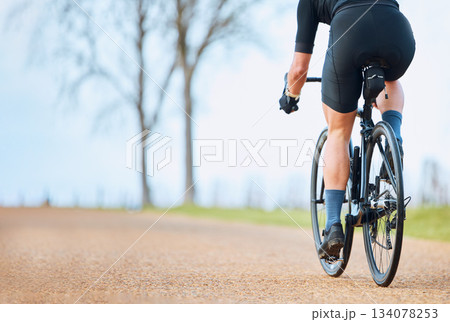 Bicycle, outdoor and person on a bike ride with mockup for sports race on a gravel road. Fitness, exercise and fast athlete doing sport training in nature on a park trail for cardio and workout Bicycle, outdoor and person on a bike ride with mockup for sports race on a gravel road. Fitness, exercise and fast athlete doing sport training in nature on a park trail for cardio and workout 134078253