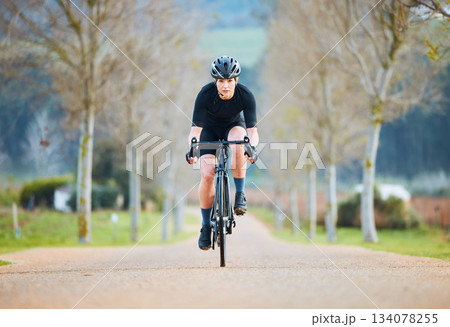 Cycling, fitness and travel with woman in park path for training, workout and health. Exercise, race and freedom with female cyclist riding on bike in nature for adventure, journey and transport 134078255