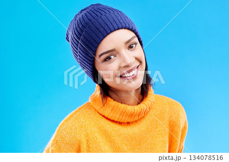 Portrait of happy woman in winter fashion with smile, beanie and jersey isolated on blue background. Style, happiness and face of gen z girl in studio with hat and warm clothing for cold weather. Portrait of happy woman in winter fashion with smile, beanie and jersey isolated on blue background. Style, happiness and face of gen z girl in studio with hat and warm clothing for cold weather. 134078516