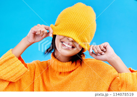 Fashion, happy and hide with woman and beanie in studio for cover, winter and goofy. Playful, happiness and smile with female and knitted hat isolated on blue background for funny, silly and cool Fashion, happy and hide with woman and beanie in studio for cover, winter and goofy. Playful, happiness and smile with female and knitted hat isolated on blue background for funny, silly and cool 134078519