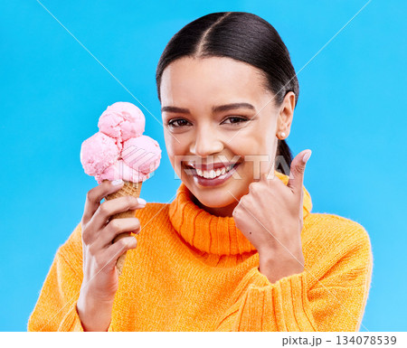 Woman, studio portrait and ice cream with thumbs up, smile and happiness by blue background. Girl, model and sweet dessert with hand sign, happy and excited for food, gelato and eating by backdrop Woman, studio portrait and ice cream with thumbs up, smile and happiness by blue background. Girl, model and sweet dessert with hand sign, happy and excited for food, gelato and eating by backdrop 134078539